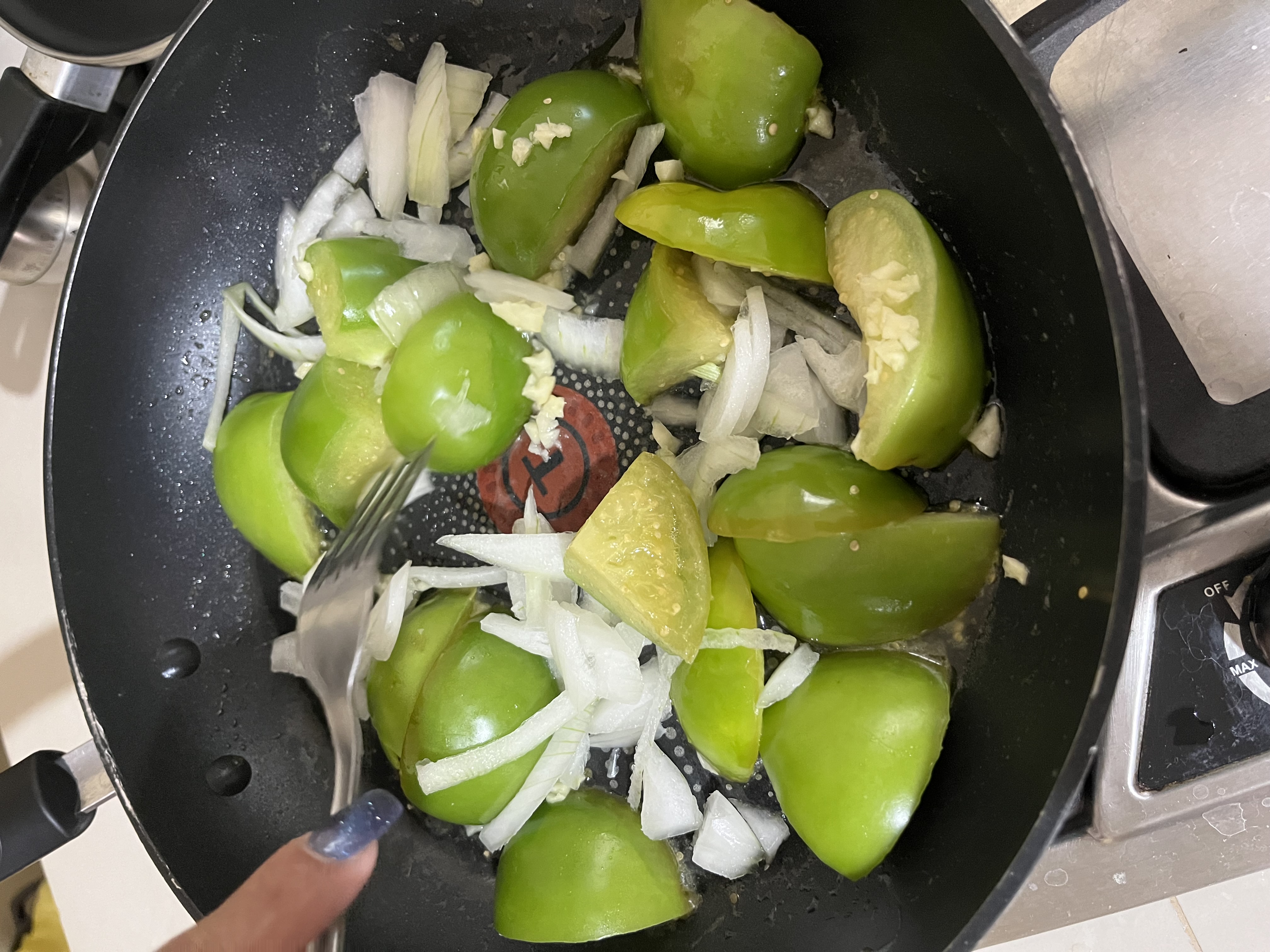 The half onion and garlic clove have now been chopped and added to the pan with the tomatoes. We're making progress!